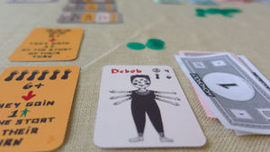 Board game elements, cards, tokens, and play money.