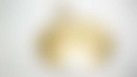 An image of a sun made out of tin foil embossing.