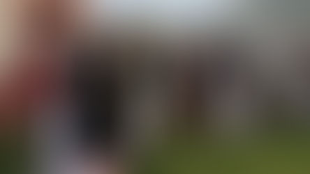 People dressed in 18th-century style costumes walking outdoors during a live action role-play (larp) event, showing immersive historical role-play.