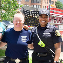 Two female firefighters smiling from the Philadelphia Fire Department. At the We Are One Kickball Tournament Event.