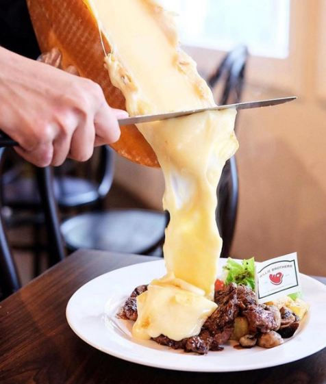 melted raclette on steak