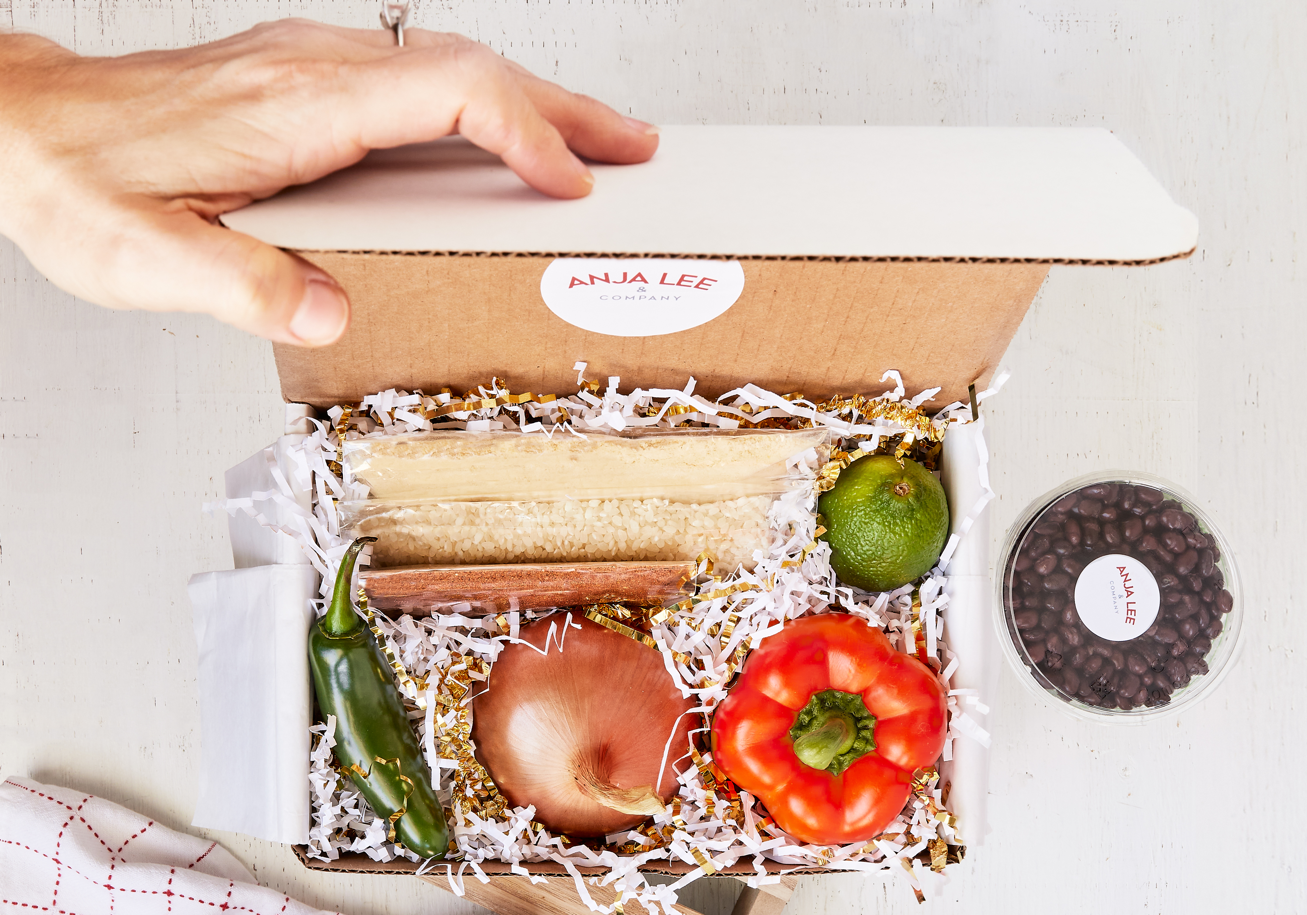 Cooking kit with tortillas, onion, tomato, lime and a green chile