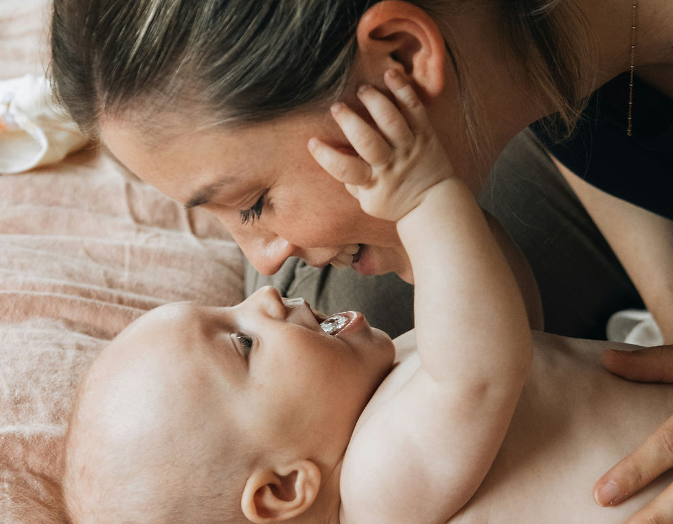 Mother holding baby while after recovering from postnatal depression | The Harvest Clinic