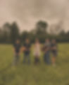 Picture of band members in open field.