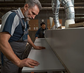 Craftsman building custom kitchen cabinets in workshop