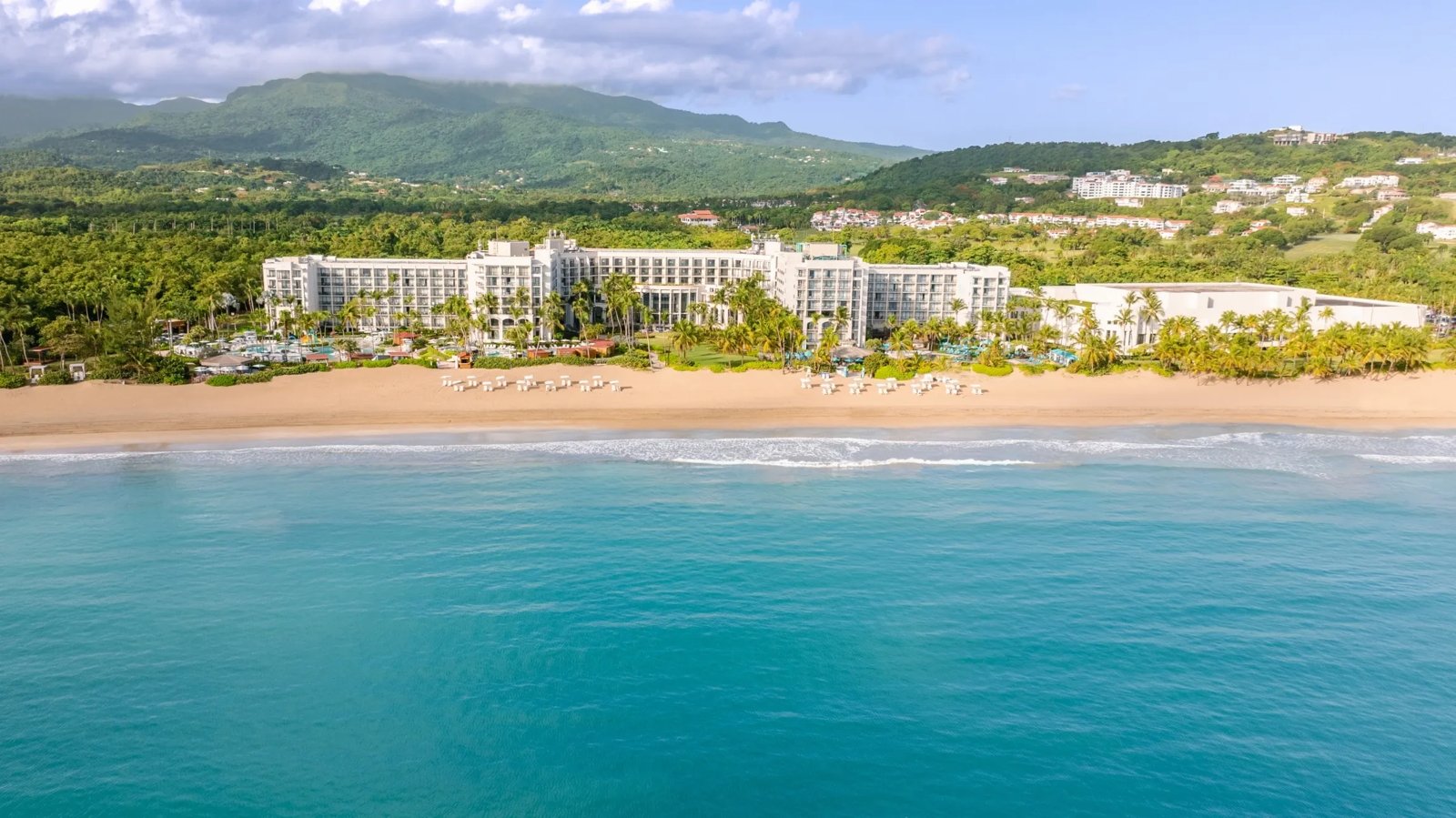 Wyndham Grand Rio Mar beachfront resort with the ocean and rainforest hills in Rio Grande, Puerto Rico