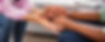 Close up of hands: one person holding the hands of another with a caring demeanor.