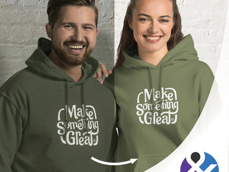Two smiling people in green hoodies with "Make Something Great" text. Background is a white brick wall.