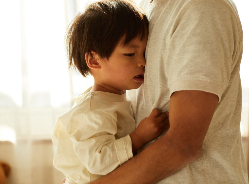 a little boy hugging his dad