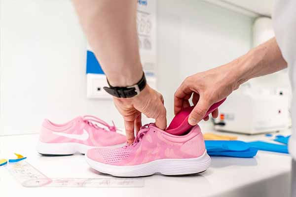 You'll likely be asked to use a heel raise insert in your shoe.