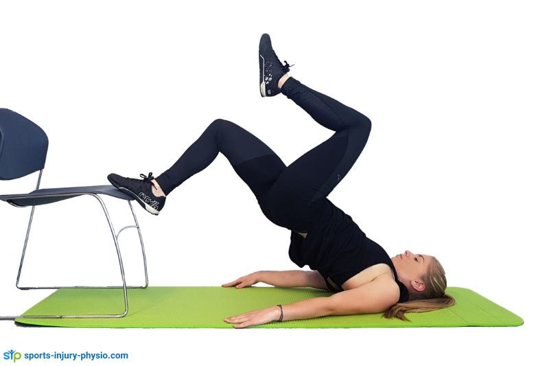 A runner performing the single leg bridge test.