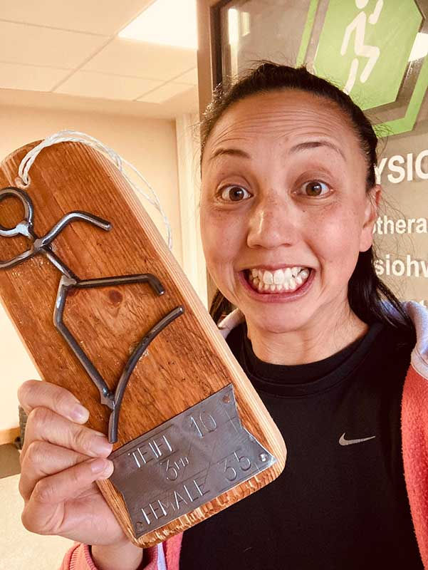 Steph looking happy holding her 3rd place trophy for the first race she ran after recovering from her insertional Achilles tendonitis.