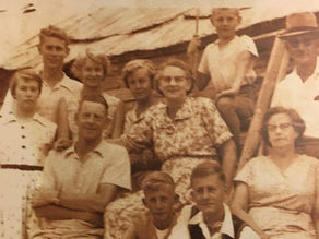 An old family picture in brown and white of several generations of the Louw family.
