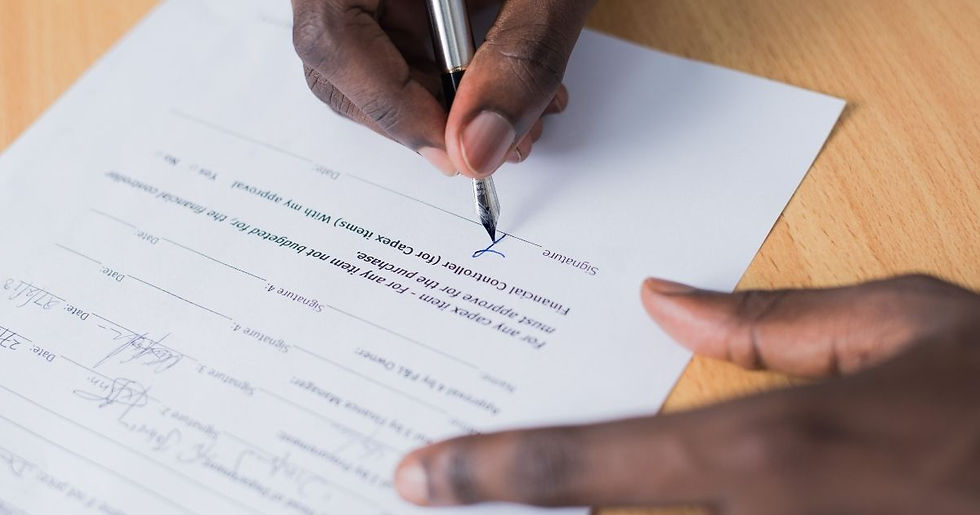 A person signing their Will.