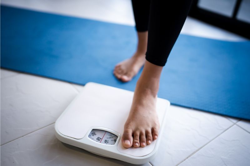 Woman stepping onto scales