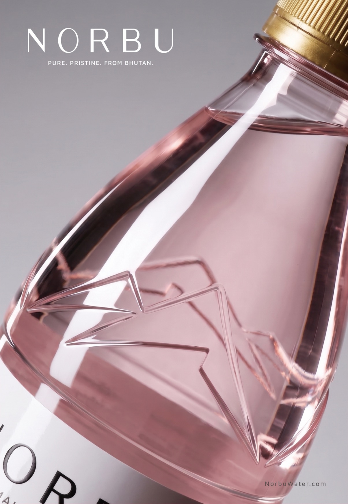 NORBU mountain motif embossed into a pink bottle