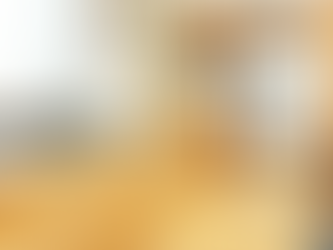 Modern kitchen with sleek bamboo cabinets and stainless steel appliances, featuring a double sink, quartz countertops, and ample natural light.