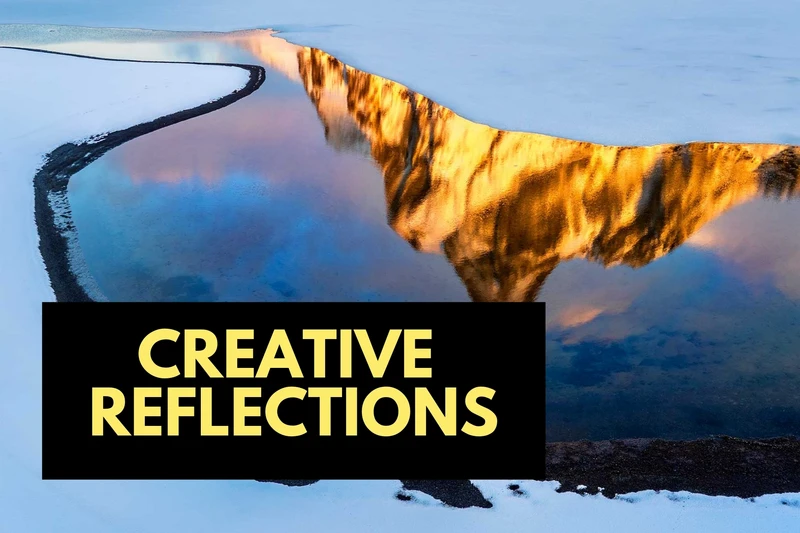 a reflection of a mountain in a body of water