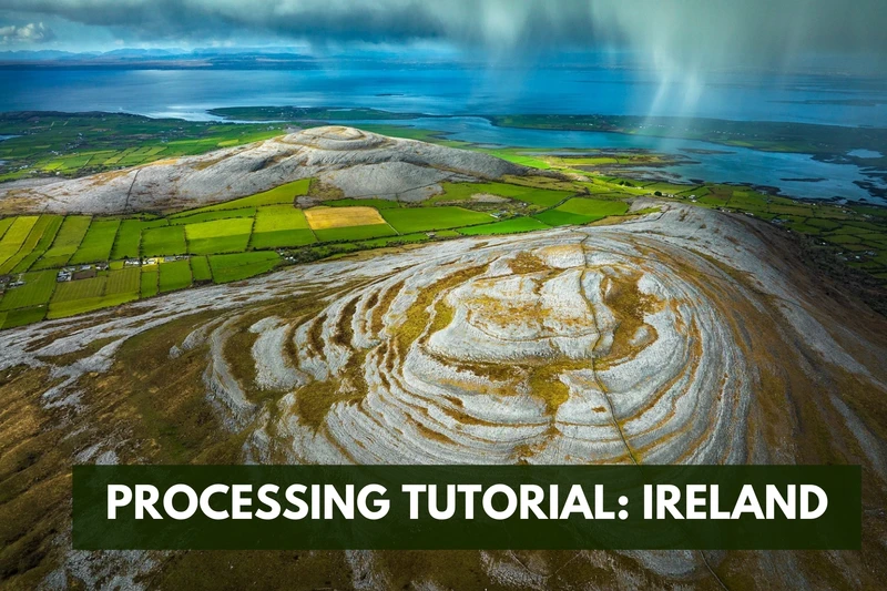 an aerial view of a mountain with a lake in the background