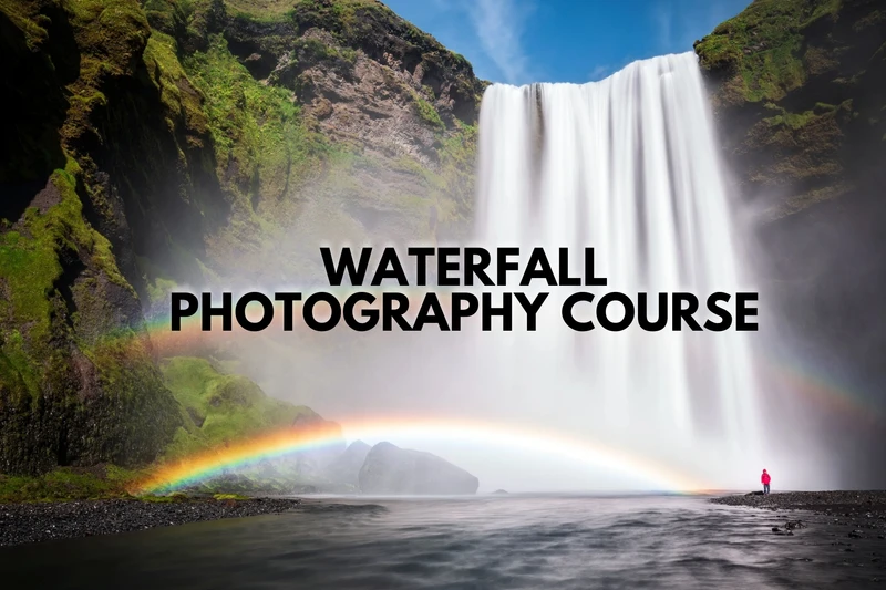a waterfall with a rainbow in the background