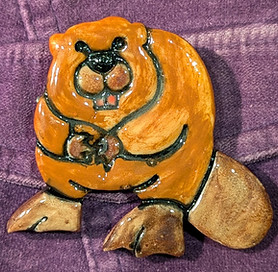 A beaver brooch on a purple velvet jacket
