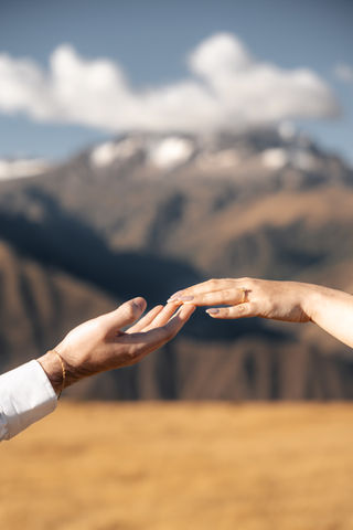 Close-up of engagement ring exchange during a mountain proposal in the Sacred Valley, Peru.