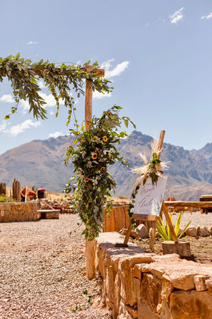 Rustic wedding arch with mountain backdrop in the Sacred Valley, Peru.