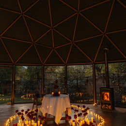 Private table setup with candlelight inside a geodesic dome in Ollantaytambo Peru