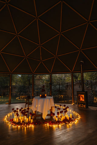 Private table setup with candlelight inside a geodesic dome in Ollantaytambo Peru