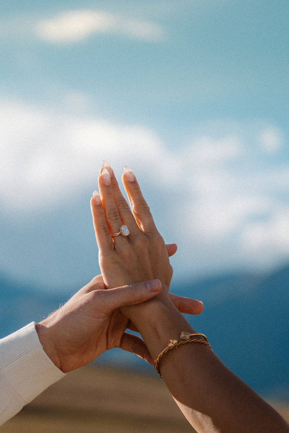 Close-up of Lexis’s diamond engagement ring as Andrew gently holds her hand after their surprise marriage proposal in the Sacred Valley, Cusco, Peru.