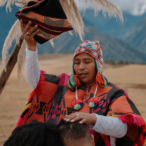 Andean priest giving a traditional blessing during a sacred ceremony
