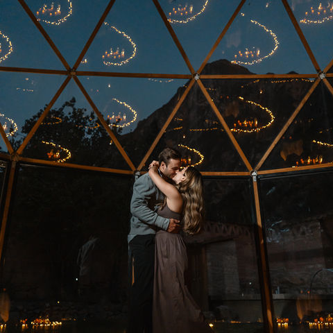 Close up of couple embracing after a surprise proposal inside a dome in Ollantaytambo Peru