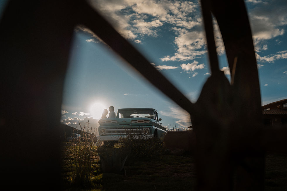 Romantic proposal and engagement photography in Cusco, Peru, featuring Andrew and Lexis silhouetted beside a vintage Chevrolet pickup truck at sunset in the Sacred Valley.
