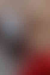 Couple interacting with a local Andean woman in traditional clothing in Ollantaytambo.