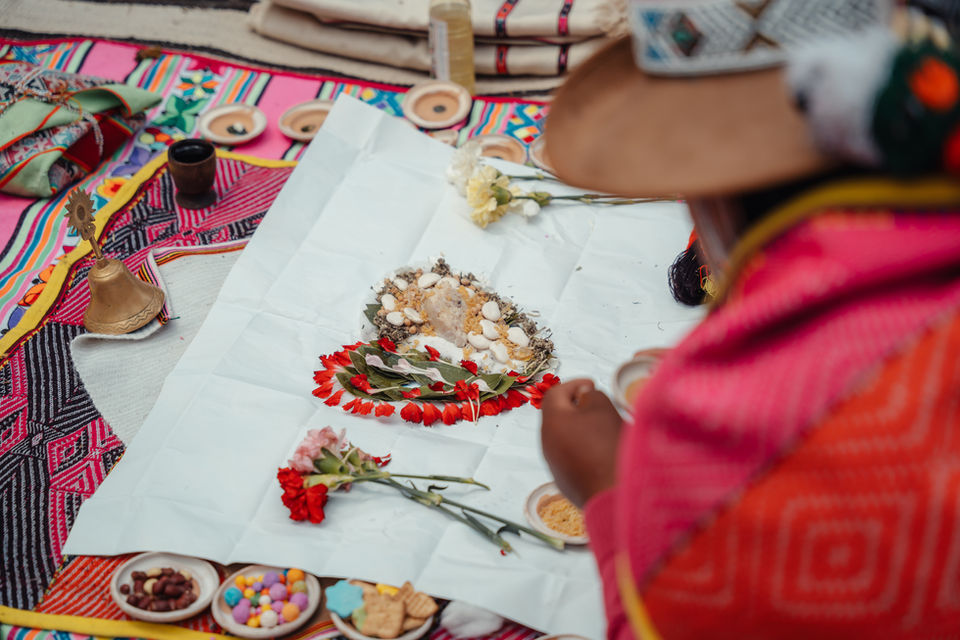 Traditional Andean despacho offering with flowers and sacred elements used in a Pachamama wedding ceremony