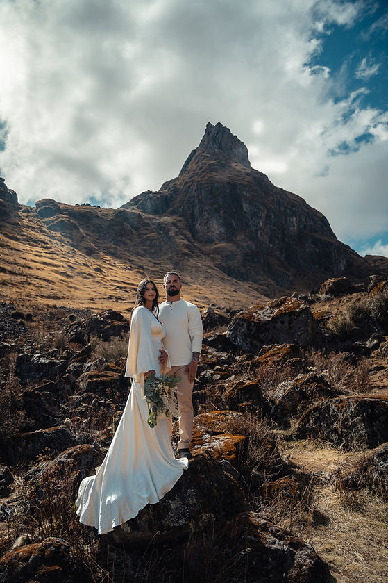 Destination elopement couple posing in the Peruvian Andes with mountain backdrop, editorial wedding photography for elopements in Cusco and the Sacred Valley
