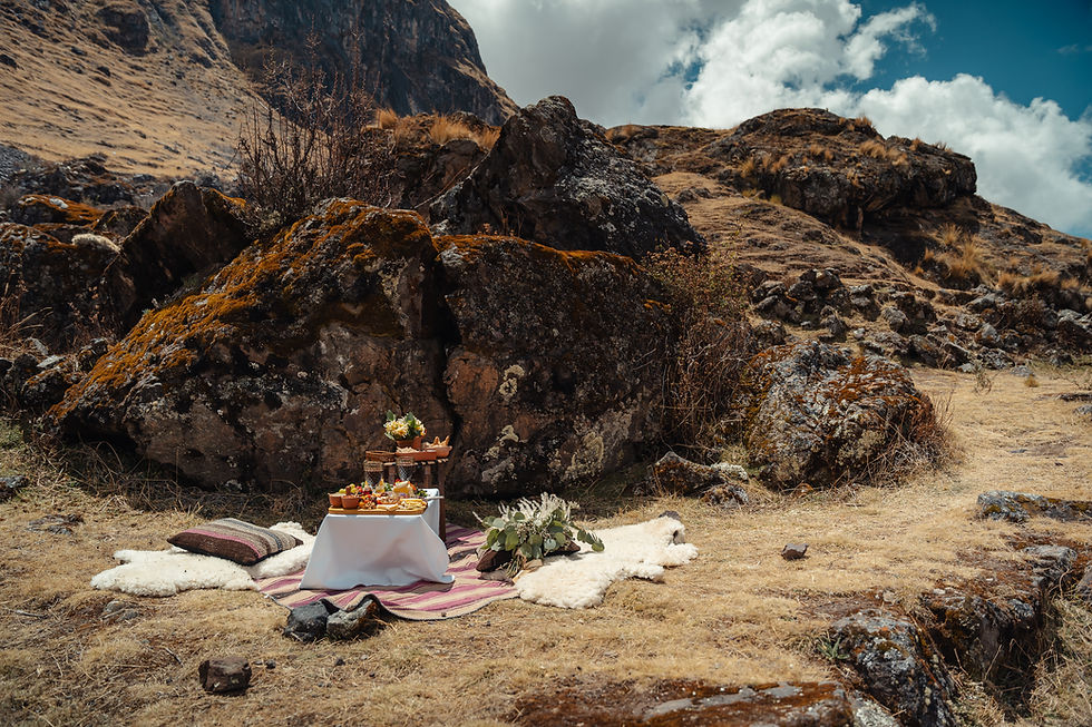 andean elopement picnic setup in cusco mountains with textiles and natural backdrop