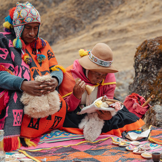 qero priests preparing despacho ceremony with offerings and textiles cusco peru