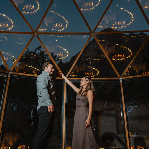Couple posing for engagement photos inside a private geodesic dome in Ollantaytambo Peru