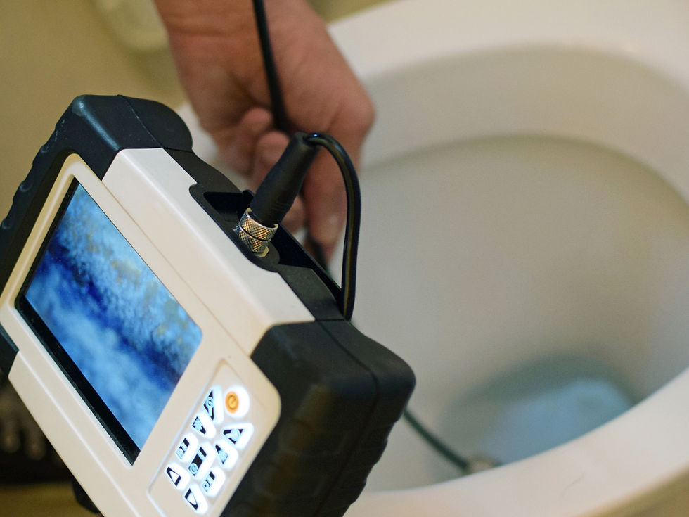 a plumber performing a video camera inspection of a toilet