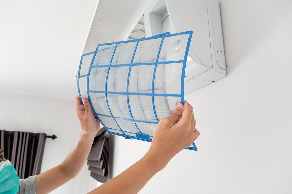 Homeowner performing a DIY filter change as part of spring HVAC maintenance to reduce allergens.