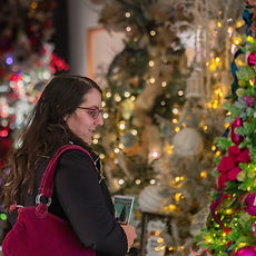 Visitor admiring decorated trees at the Easton Festival of Trees