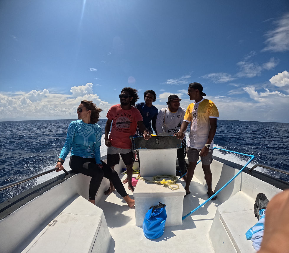The Oceancy and Baokalo team travelling by boat to a neighbouring island to monitor the health of the local reef. © Zachary Wong