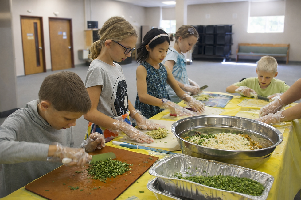 Children preparing ingredients at yellow table.png