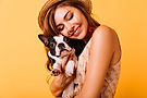 relaxed-redhaired-girl-embracing-puppy-yellow-background-studio-portrait-white-appealing-w