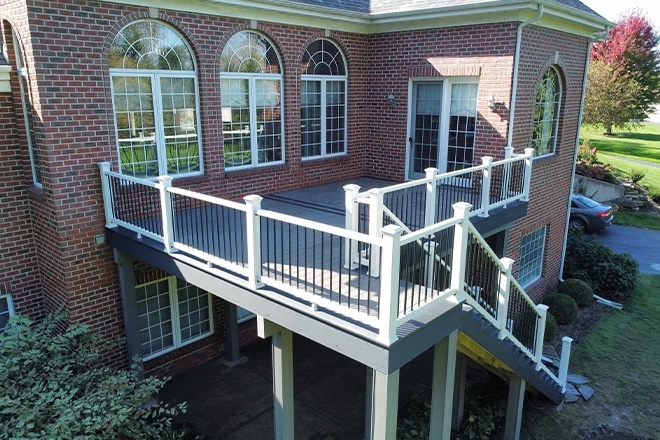 gray composite deck on a brick home