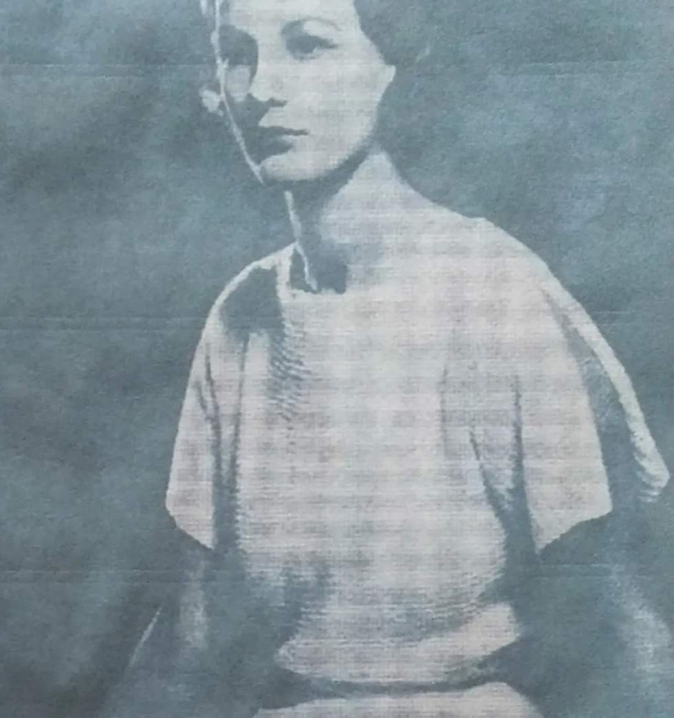 Balck and white photograph of a seated lady wearing a handknit top