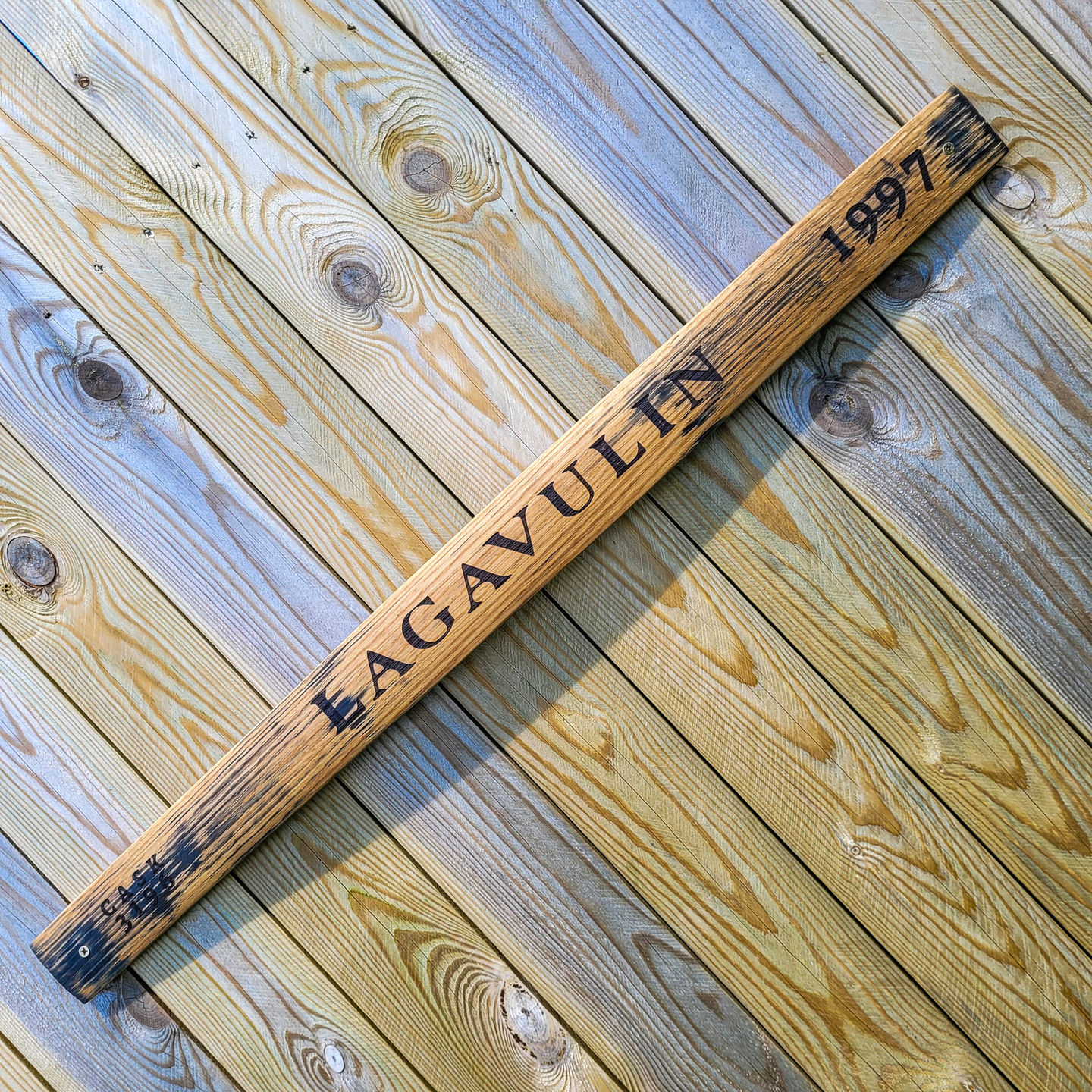Whisky barrel stave sign Lagavulin 1997 angled view showing full length reclaimed oak with original distillery markings on ru