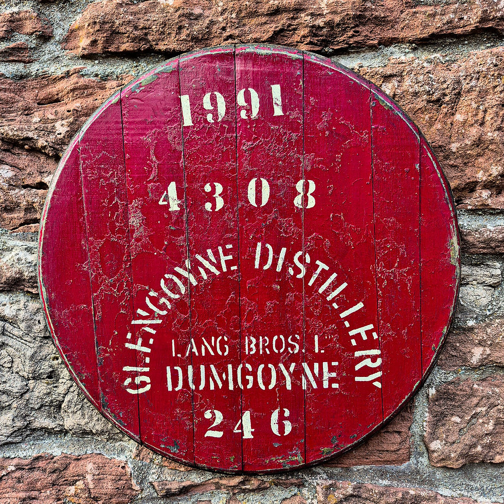 Close-up of red Glengoyne Distillery 1991 whisky barrel cask head on a stone wall.