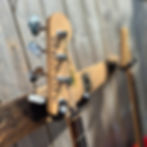 Natural oak grain and linseed oil finish on reclaimed Scotch whisky barrel stave guitar hanger close-up